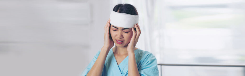 Woman experiencing post-concussion headaches